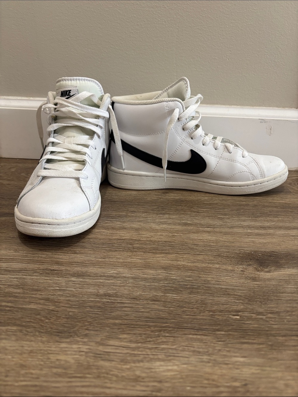 Nike White High-Top Sneakers with Black Swoosh